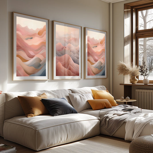 Three abstract landscape art prints depicting warm desert dunes, displayed in a sunlit room with natural decor, evoking a sense of peace and warmth