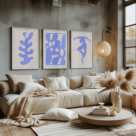 A captivating set of blue abstract and figurative prints, framed and displayed in a stylish room with warm natural light.