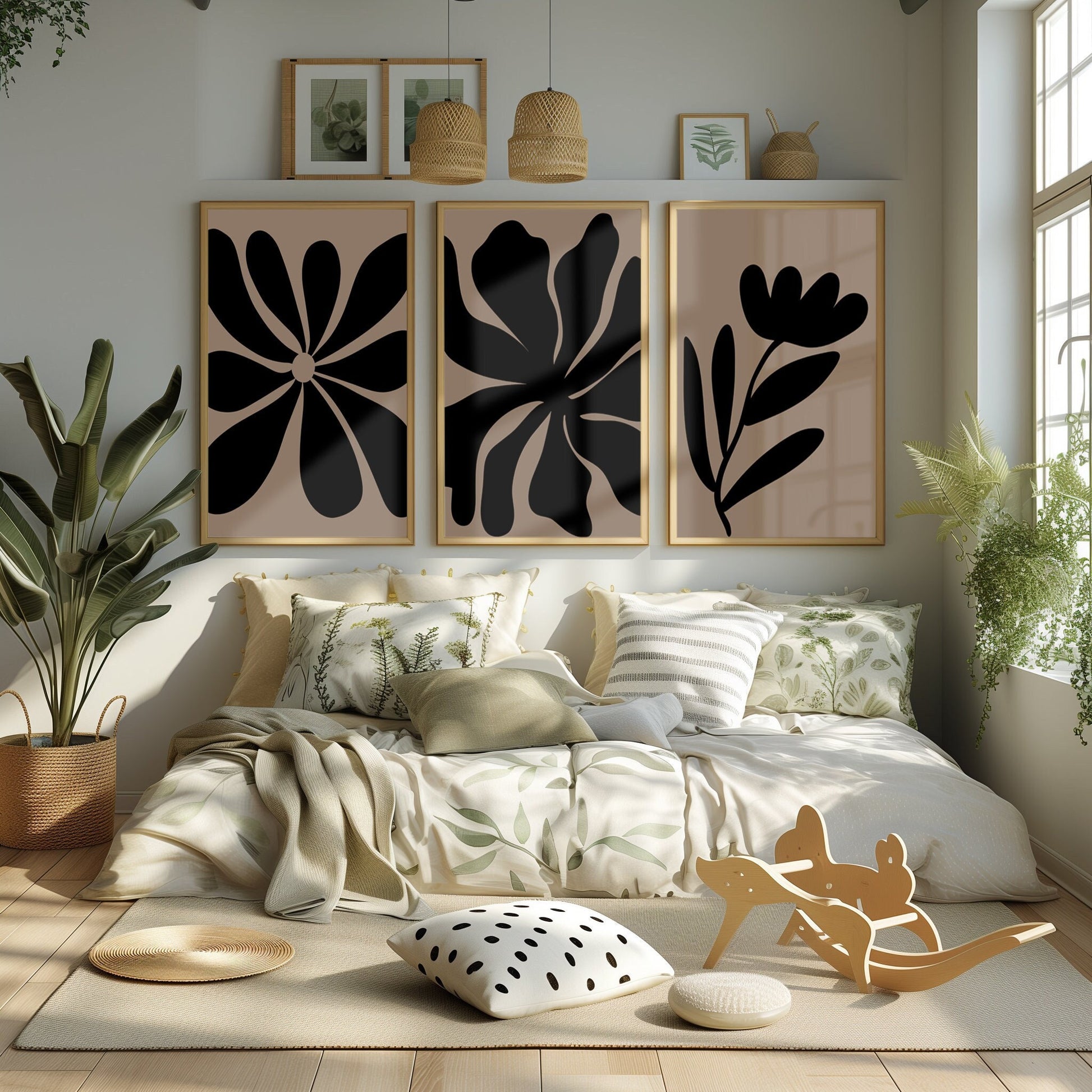 A set of three abstract botanical prints in black and tan, adding a touch of minimalist elegance to a serene bedroom ambiance.