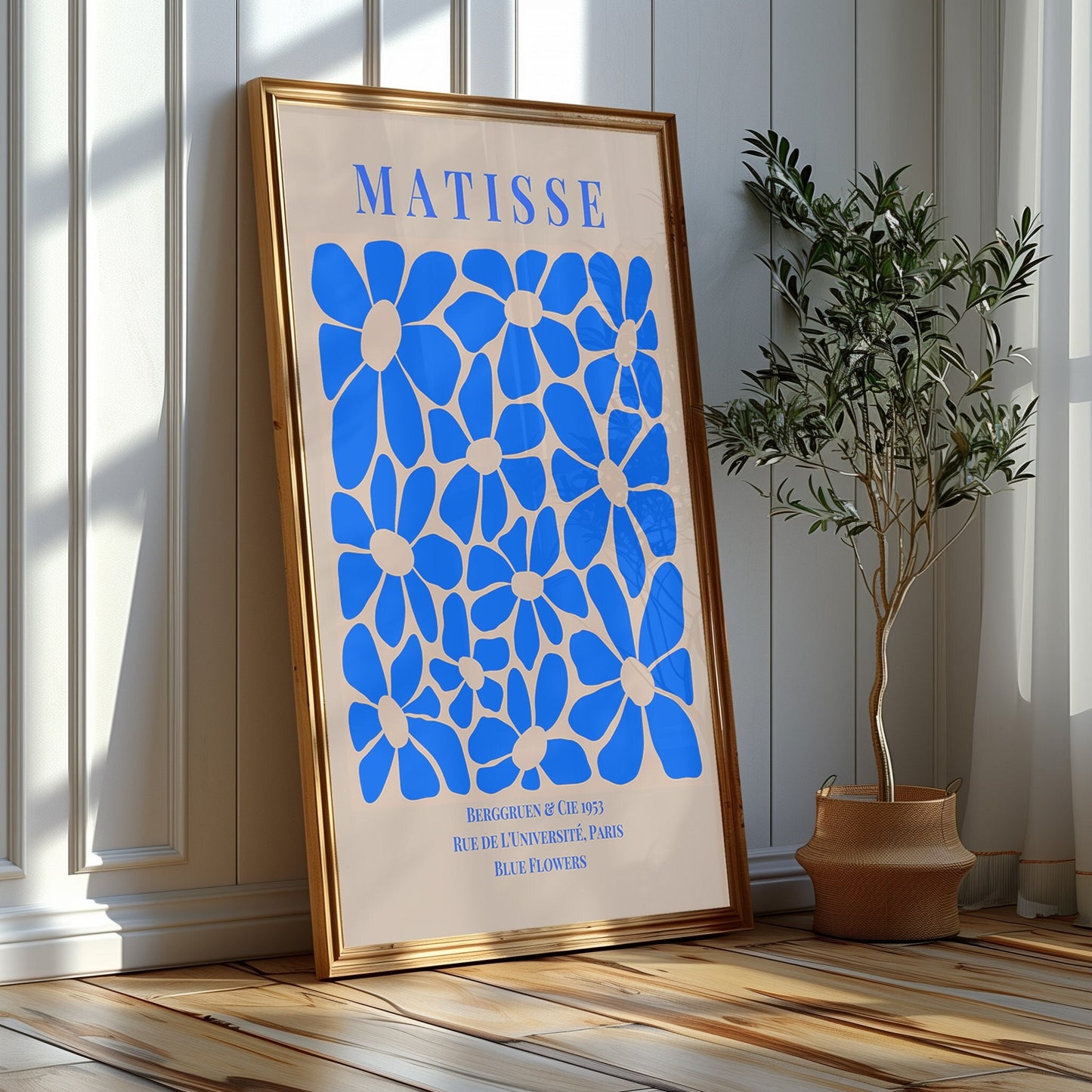 A striking series of Matisse blue prints, featuring classic cutouts and an elegant silhouette, set against a modern living room backdrop.