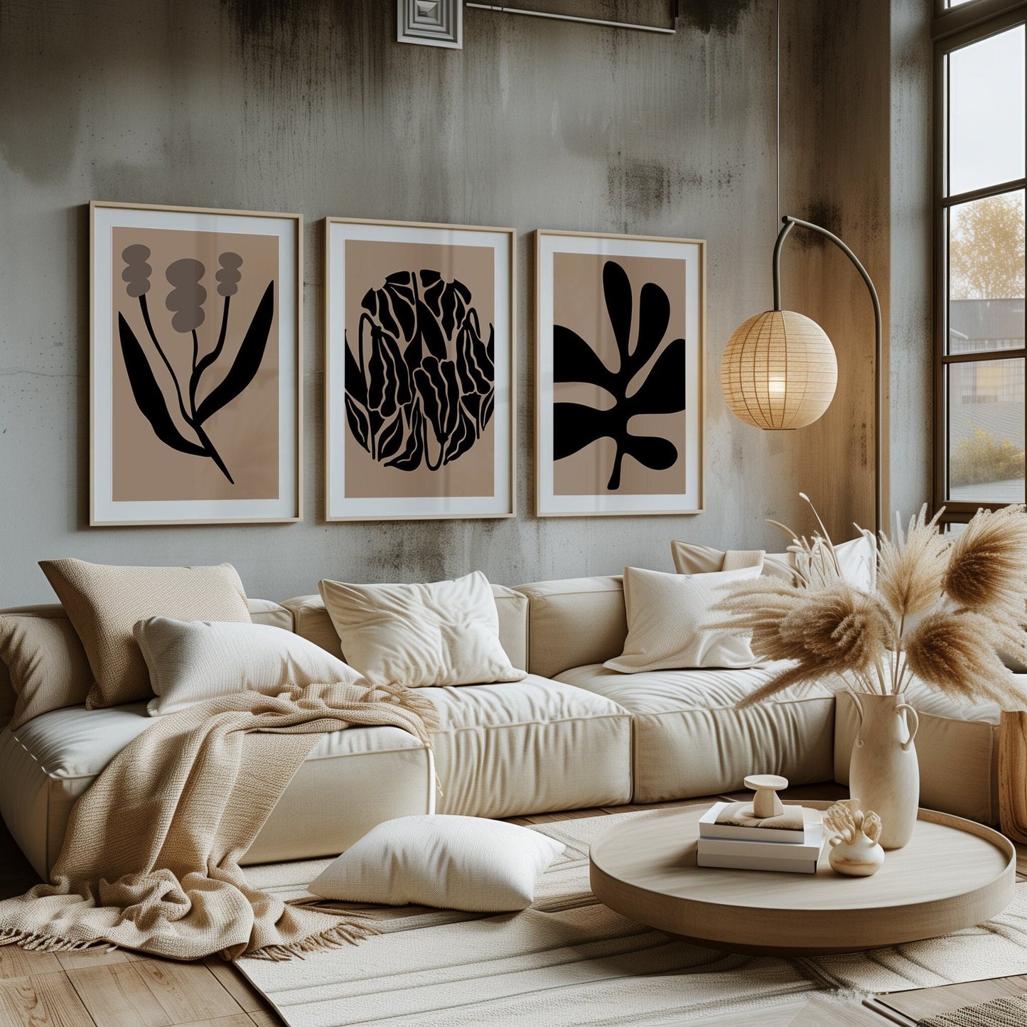 Three minimalist botanical silhouette prints in monochrome, set against a neutral backdrop, infusing modern elegance into the living space.