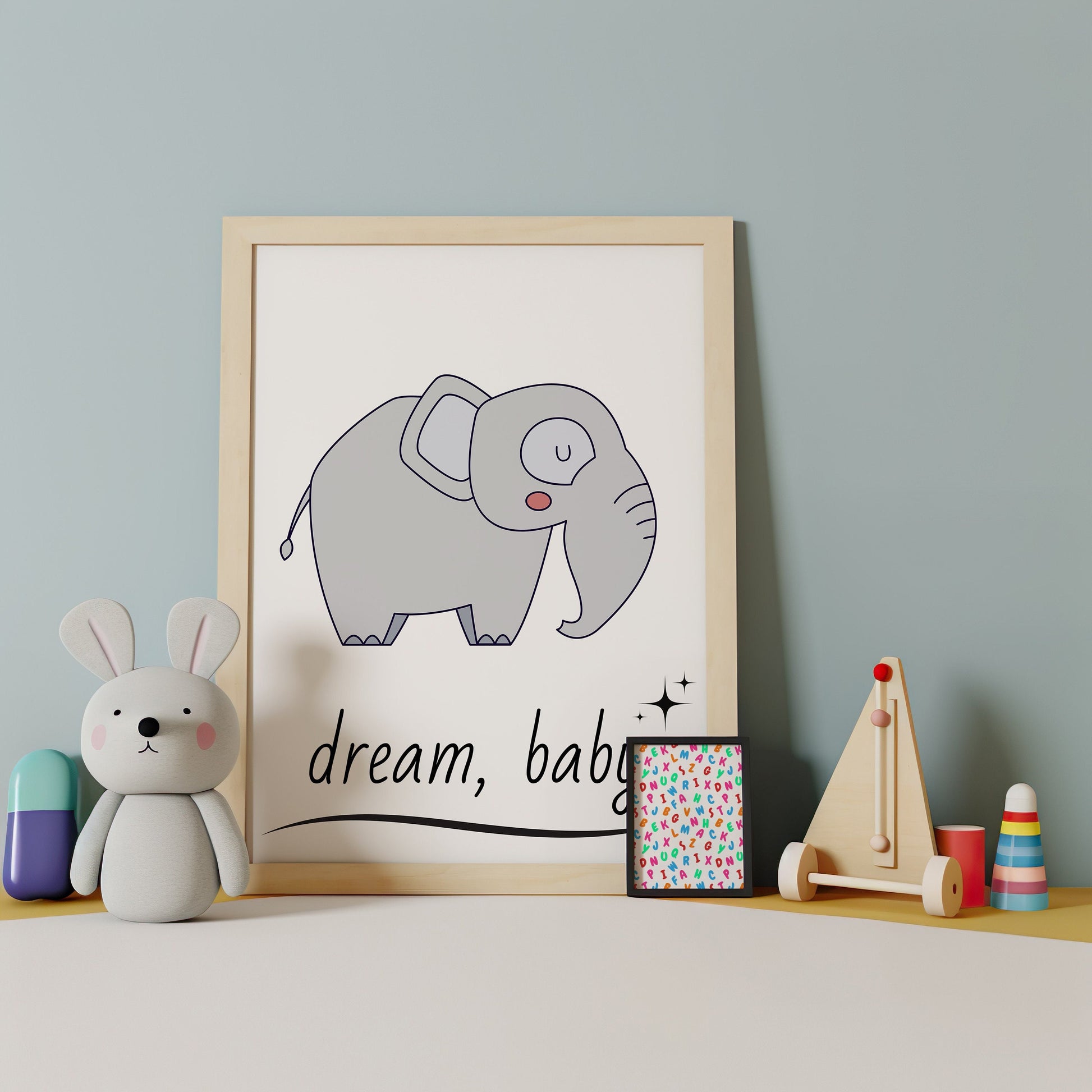 Nursery wall art featuring a cute elephant with the quote &quot;Dream Baby,&quot; perfect for kids room and nursery decor. Available as an instant digital download.