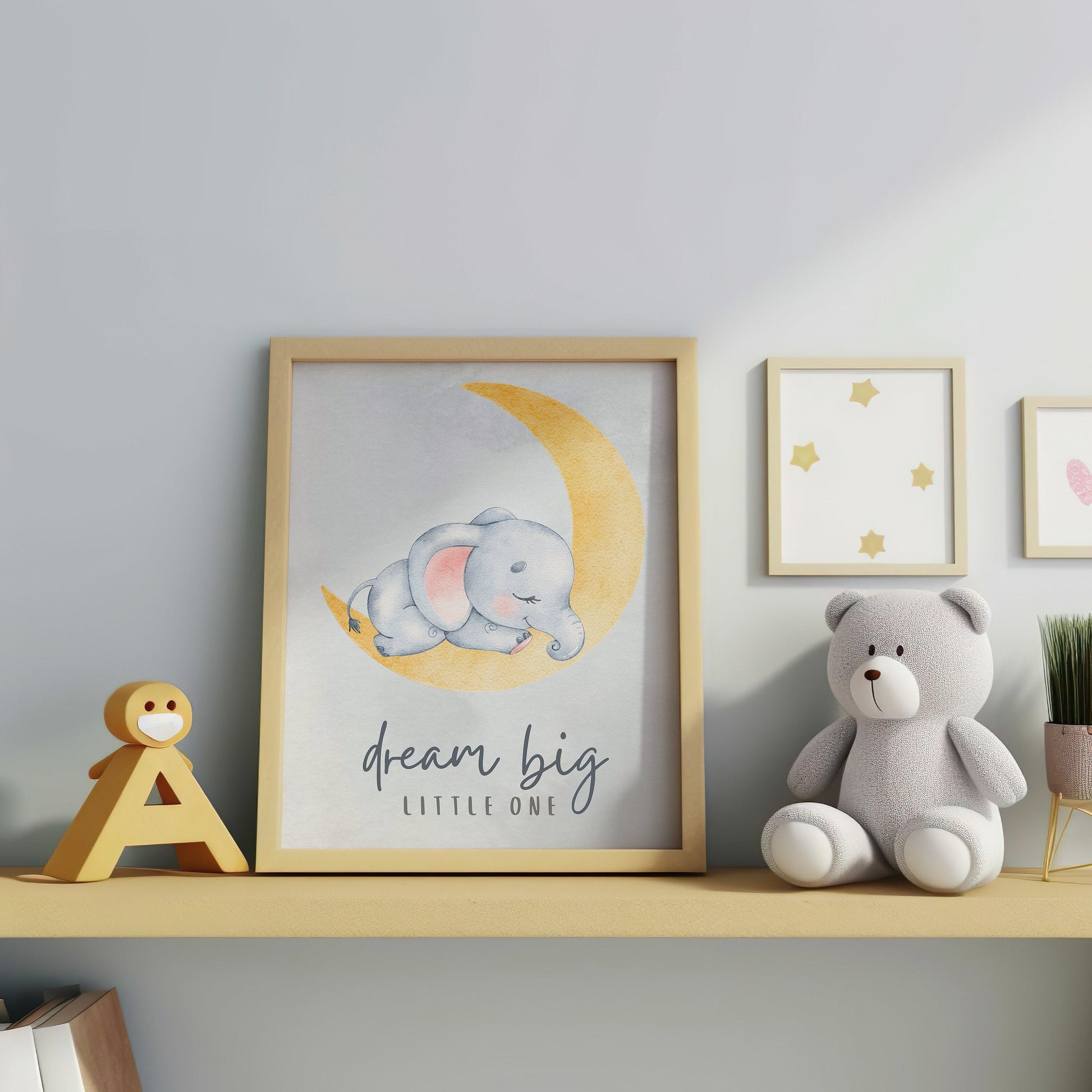 Nursery wall art featuring an adorable elephant on a crescent moon with the quote &quot;Dream Big Little One,&quot; perfect for kids room decor. Available as an instant digital download.