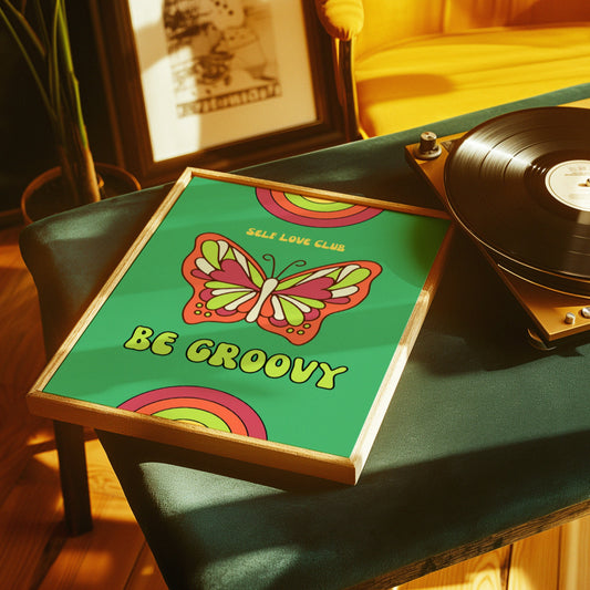 Retro-inspired poster featuring a colorful butterfly with the text &quot;Self Love Club&quot; and &quot;Be Groovy&quot; against a green background with rainbow accents. Retro poster with a colorful butterfly and the text &quot;Self Love Club&quot; and &quot;Be Groovy&quot;