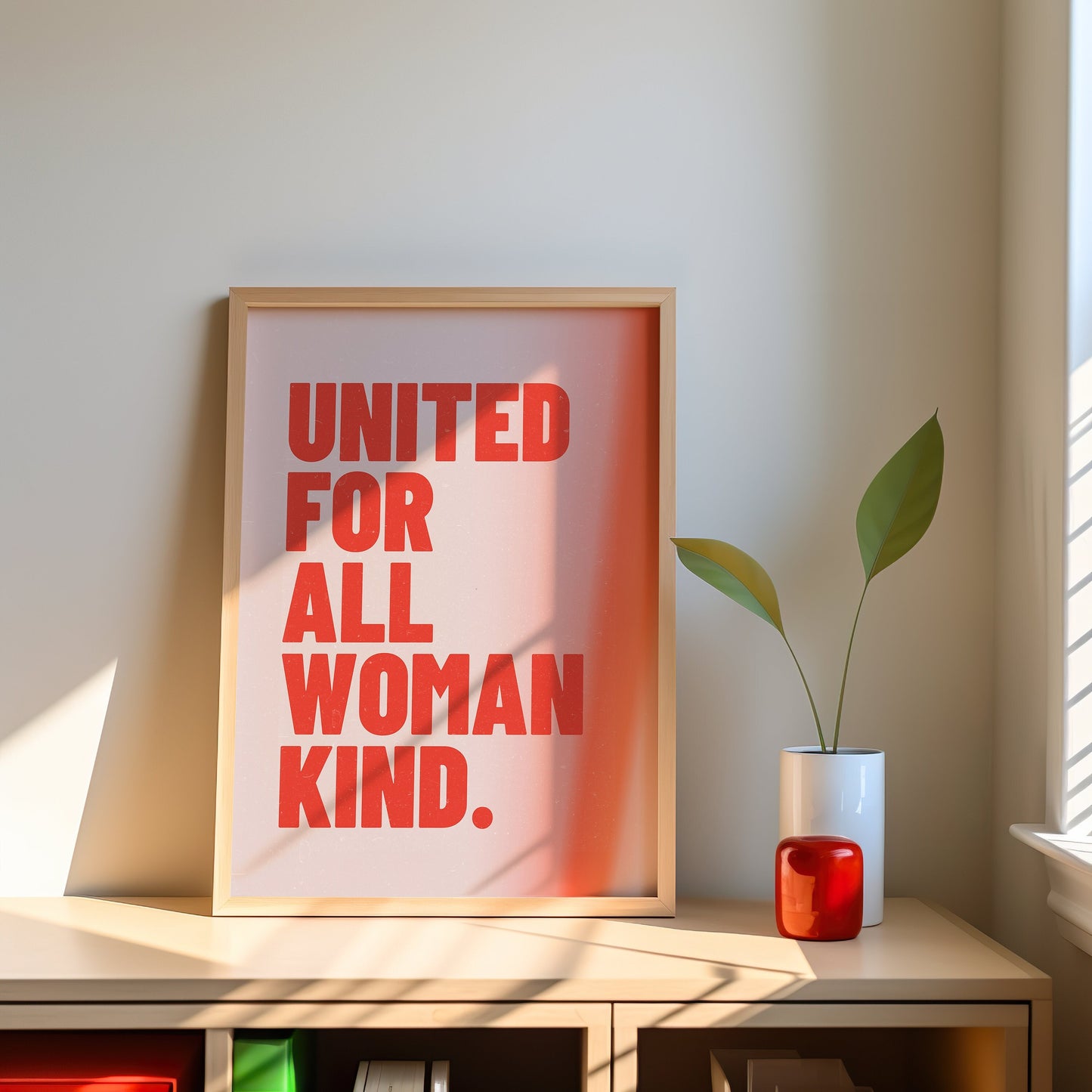 An inspirational poster with the message &quot;United for All Womankind&quot; in bold red text for feminist empowerment.