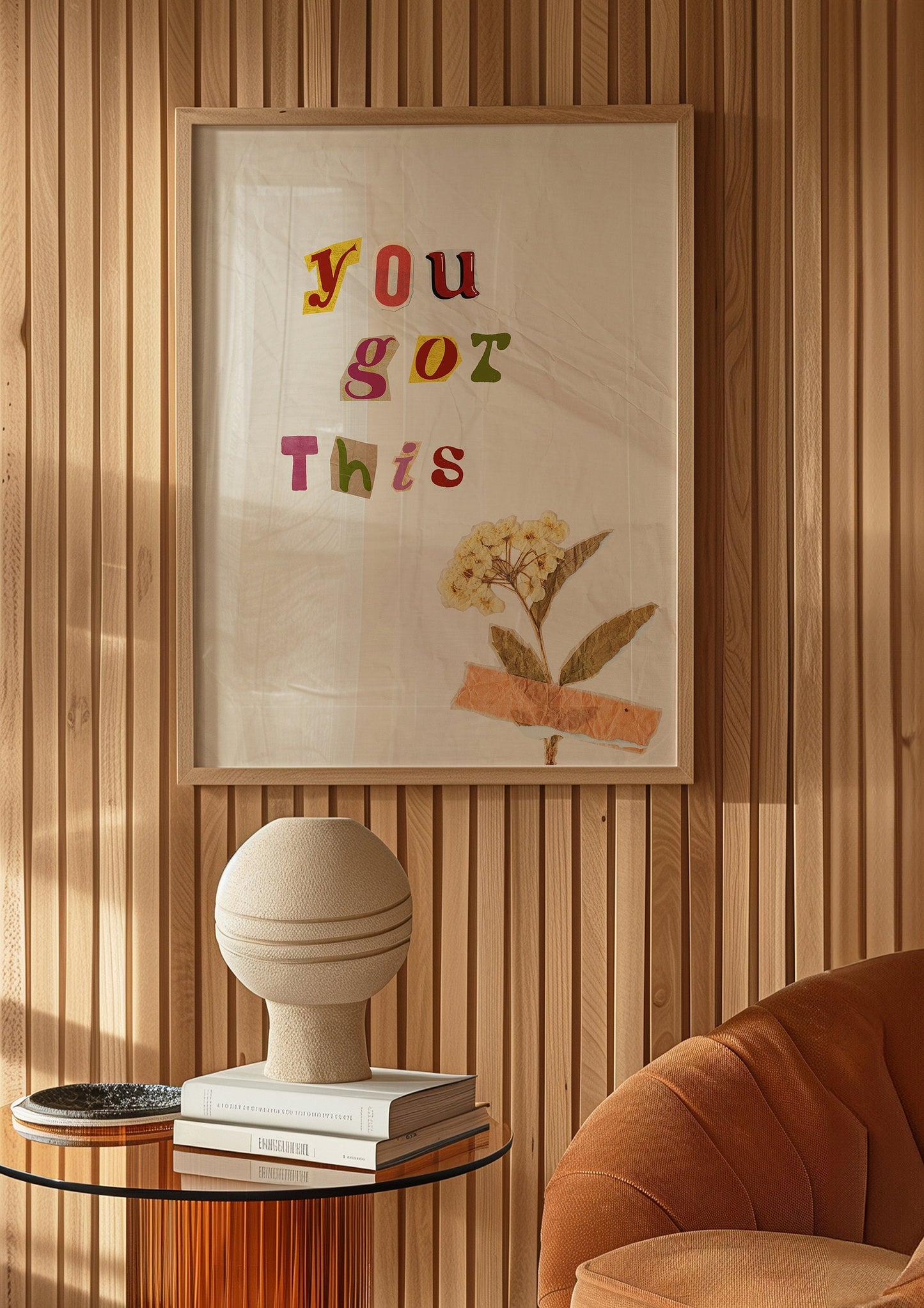 A motivational poster with the text "You Got This" in colorful letters with a dried flower taped to the background, perfect for encouraging positivity.