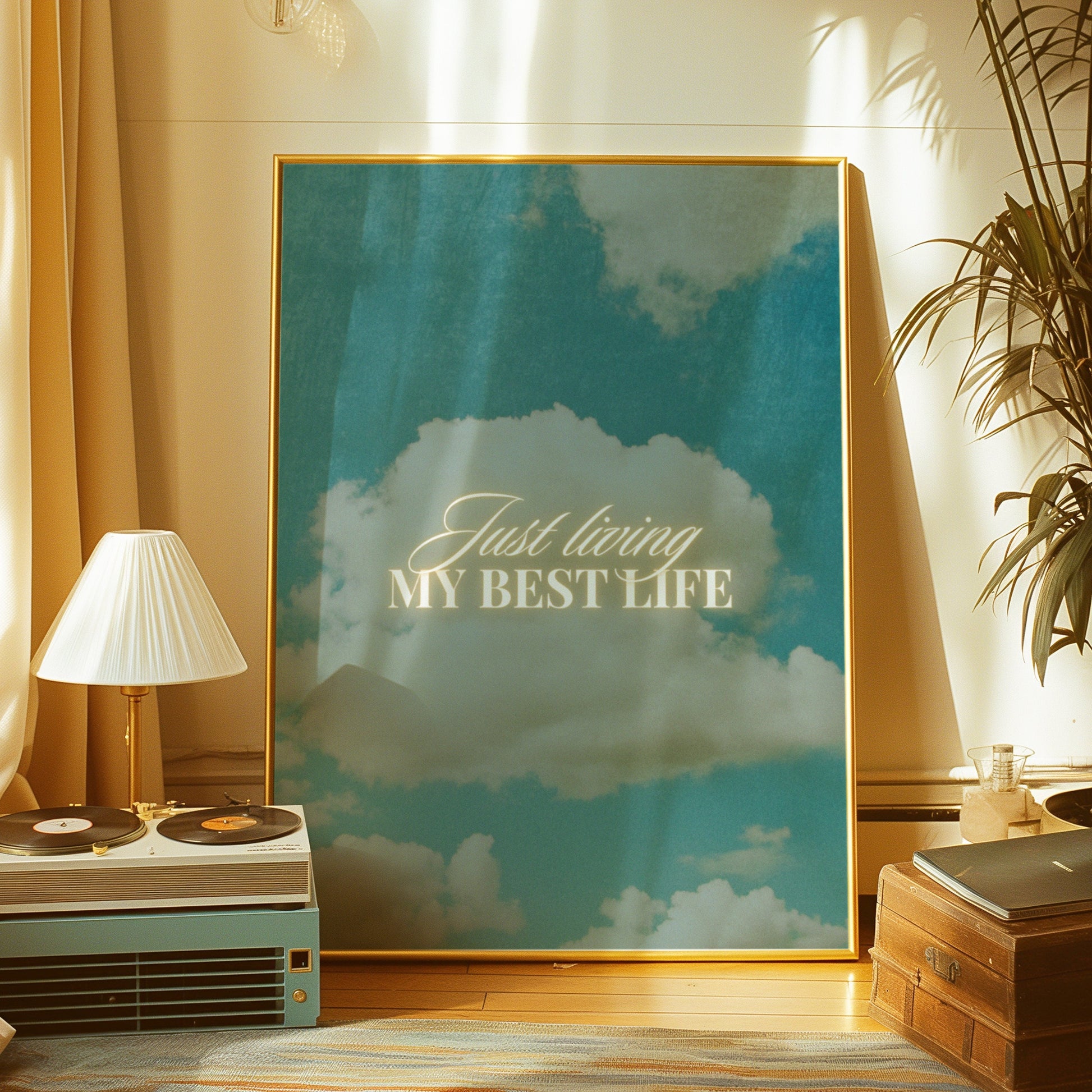 An inspirational art print with the phrase "Just living my best life" over a serene sky and clouds background.