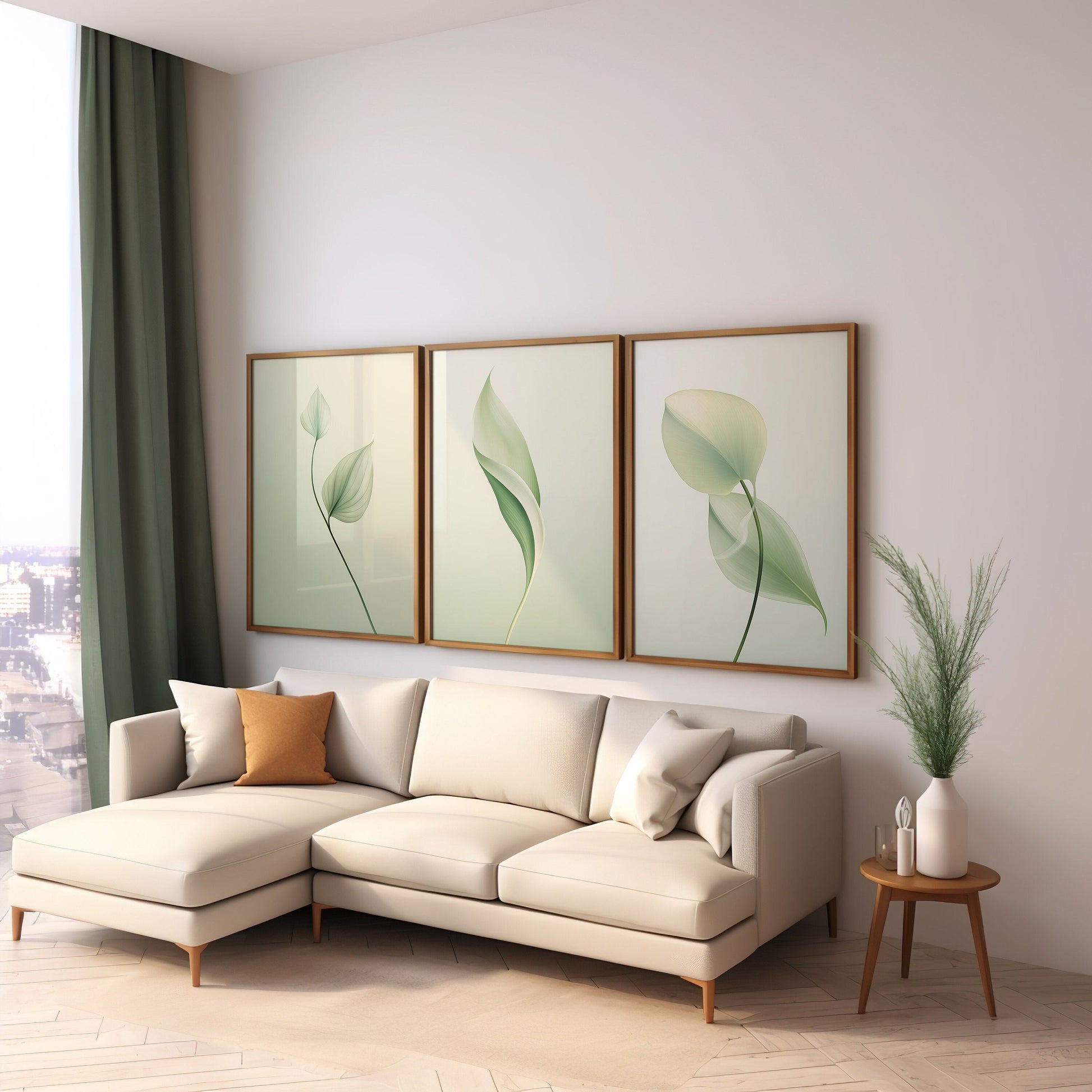 A set of three framed botanical wall art prints featuring green and yellow leaf illustrations, elegantly displayed above a wooden sideboard and next to two rattan chairs in a bright, sunlit room.