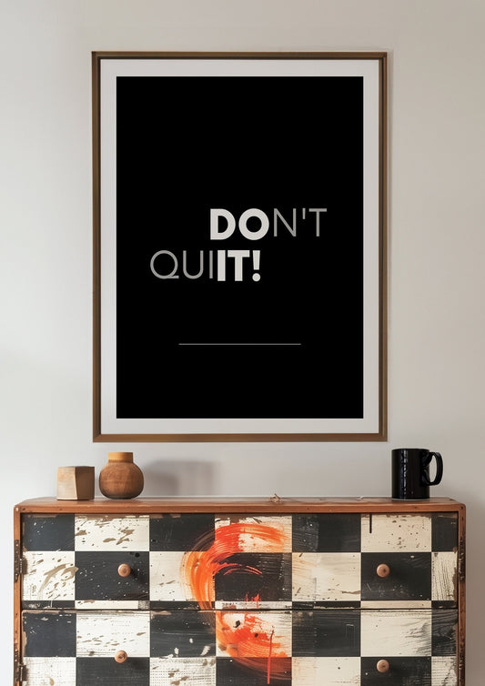 A motivational art print with the phrase &quot;Don&#39;t Quit&quot; in bold white letters on a black background.