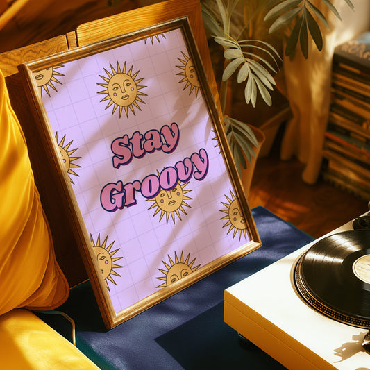 A retro-inspired poster with a purple background featuring yellow sun faces and the phrase &quot;Stay Groovy&quot; in bold purple letters.