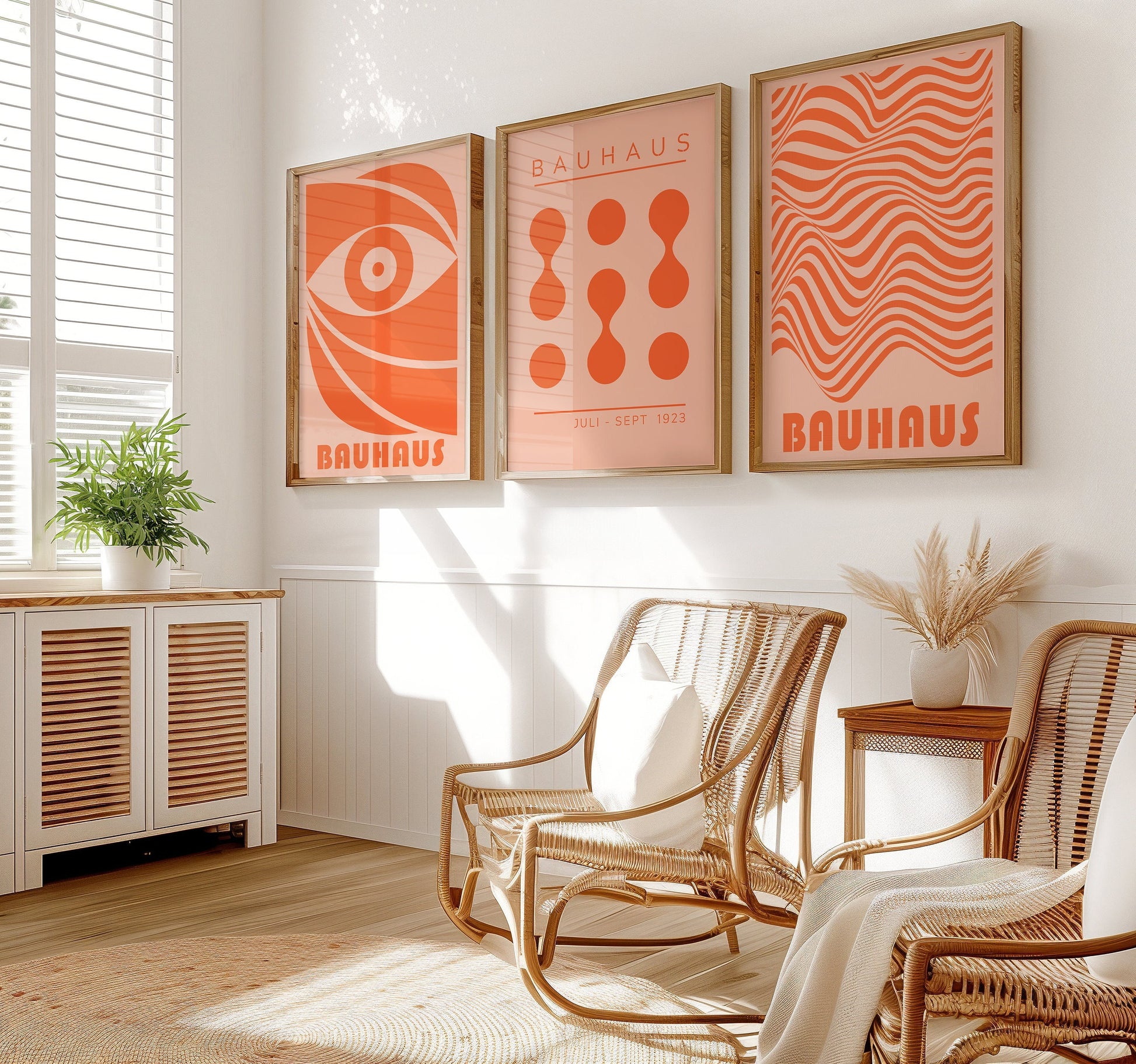 A set of three Bauhaus posters featuring abstract geometric designs in bold orange. The prints include wavy lines, dots, and an eye motif, all encapsulating the essence of Bauhaus modernist art.