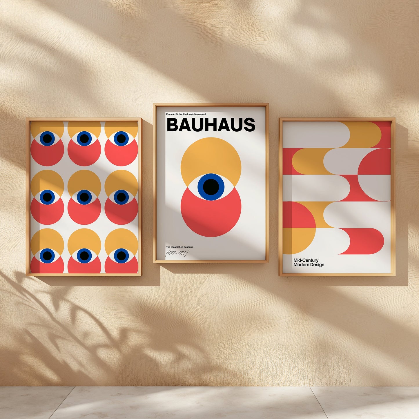 A set of three Bauhaus-inspired art prints featuring bold geometric designs in red, yellow, and blue tones, framed in light wooden frames, displayed on a minimalist shelf.