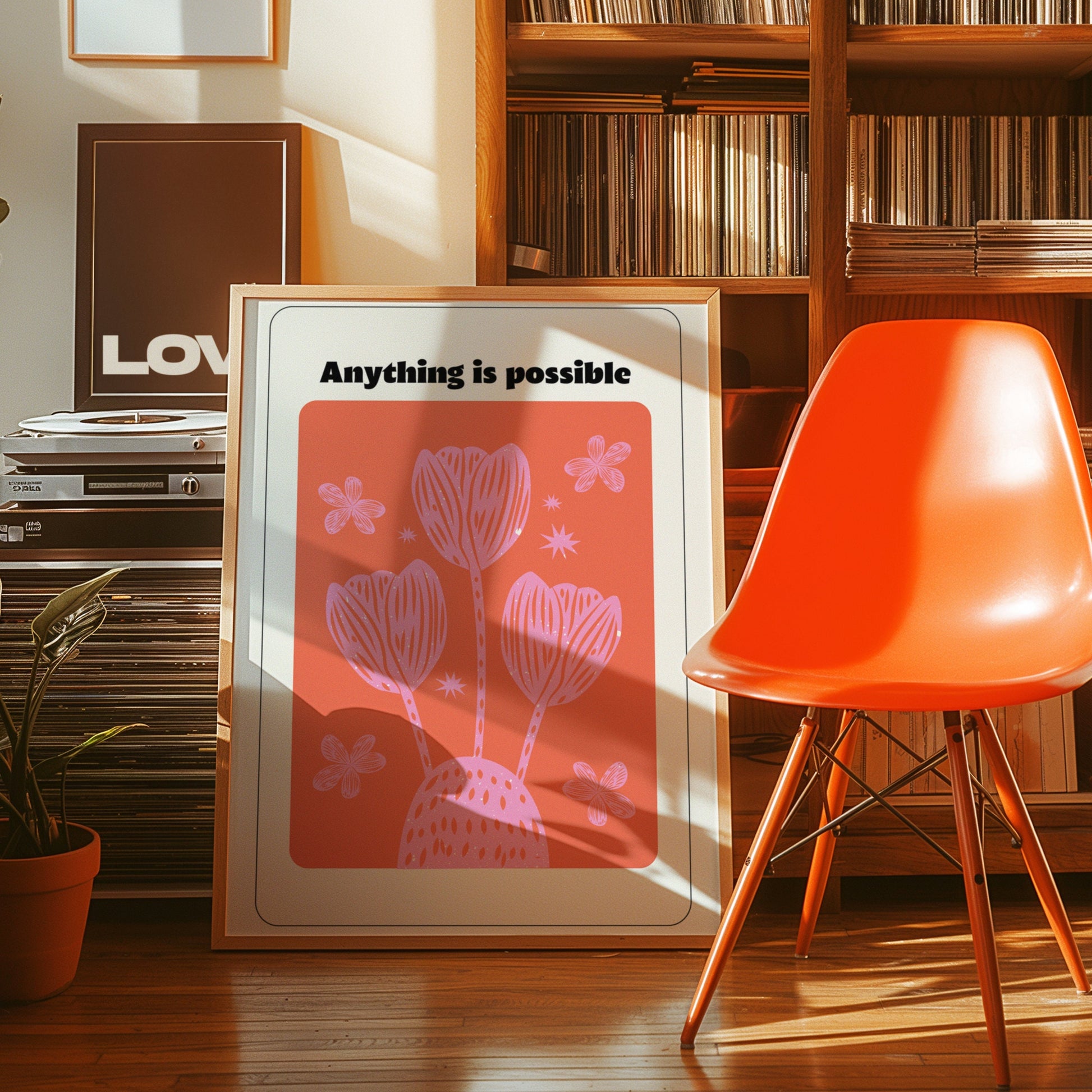 A vibrant motivational poster featuring the text "Anything is possible" above a red and pink floral design, bringing positivity and inspiration to any space.