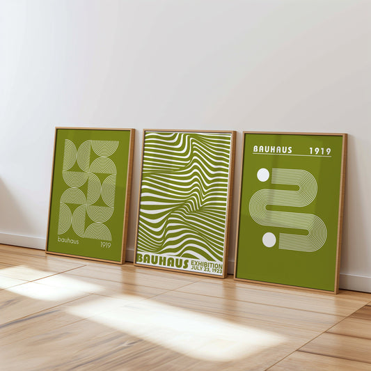 A set of three green Bauhaus posters featuring minimalist line art and abstract geometric designs, framed in light wood, perfect for adding a modern and stylish touch to any interior.