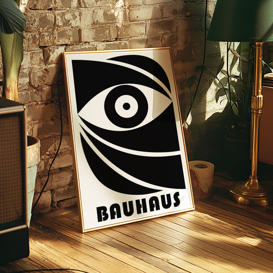 A bold Bauhaus poster featuring a stylized eye design in black and white, framed in a wooden frame and displayed by a bright window, perfect for adding a touch of modern, minimalist decor.