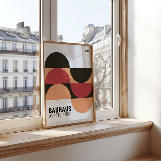 A Bauhaus Ausstellung 1919 poster displayed on a windowsill, featuring an abstract design with curved geometric shapes in shades of red, orange, and black, adding a stylish touch to the room.