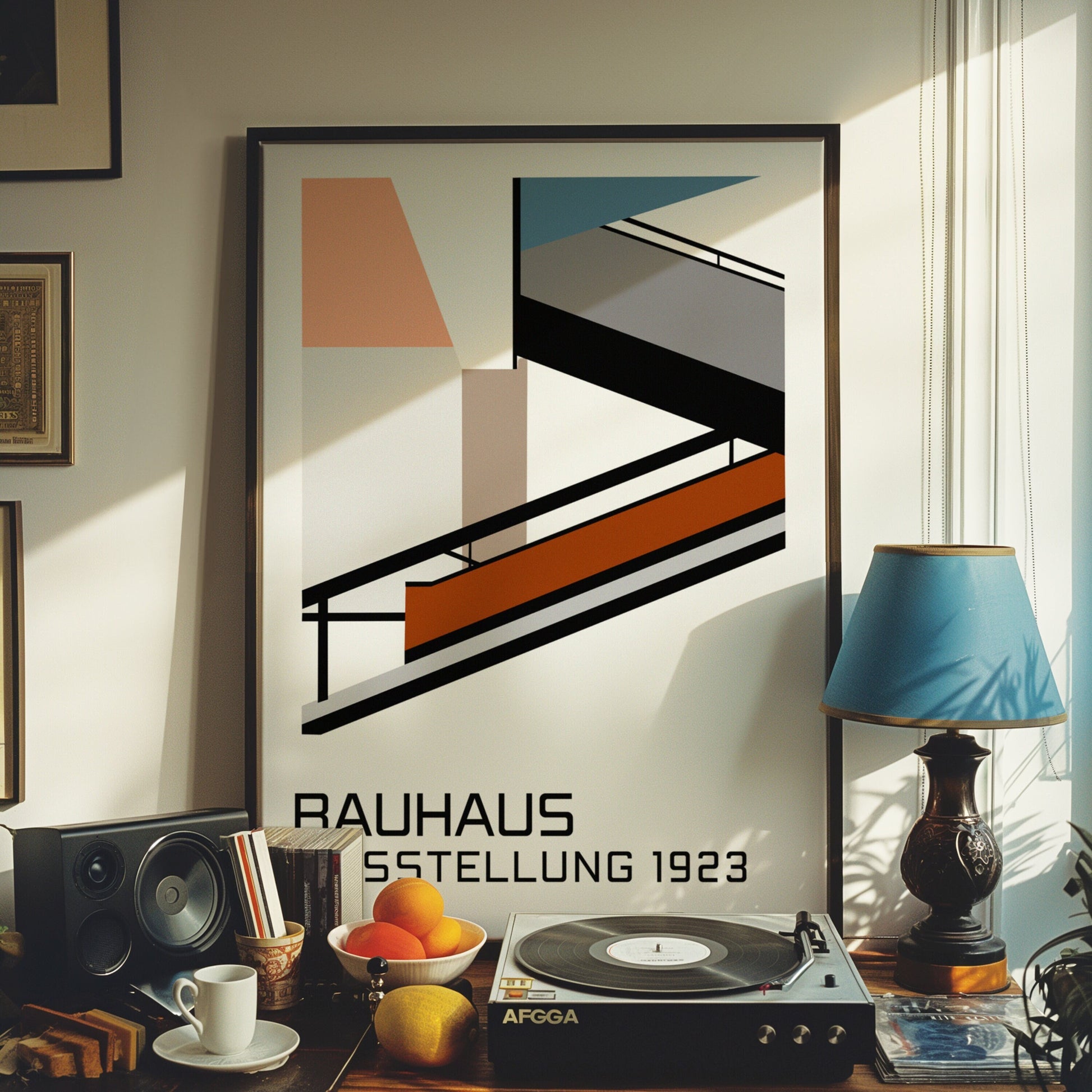 A framed Bauhaus Ausstellung 1923 poster with a retro geometric design inspired by Bauhaus architecture. The poster is displayed in a cozy room next to a vintage record player, books, and a cup of coffee.