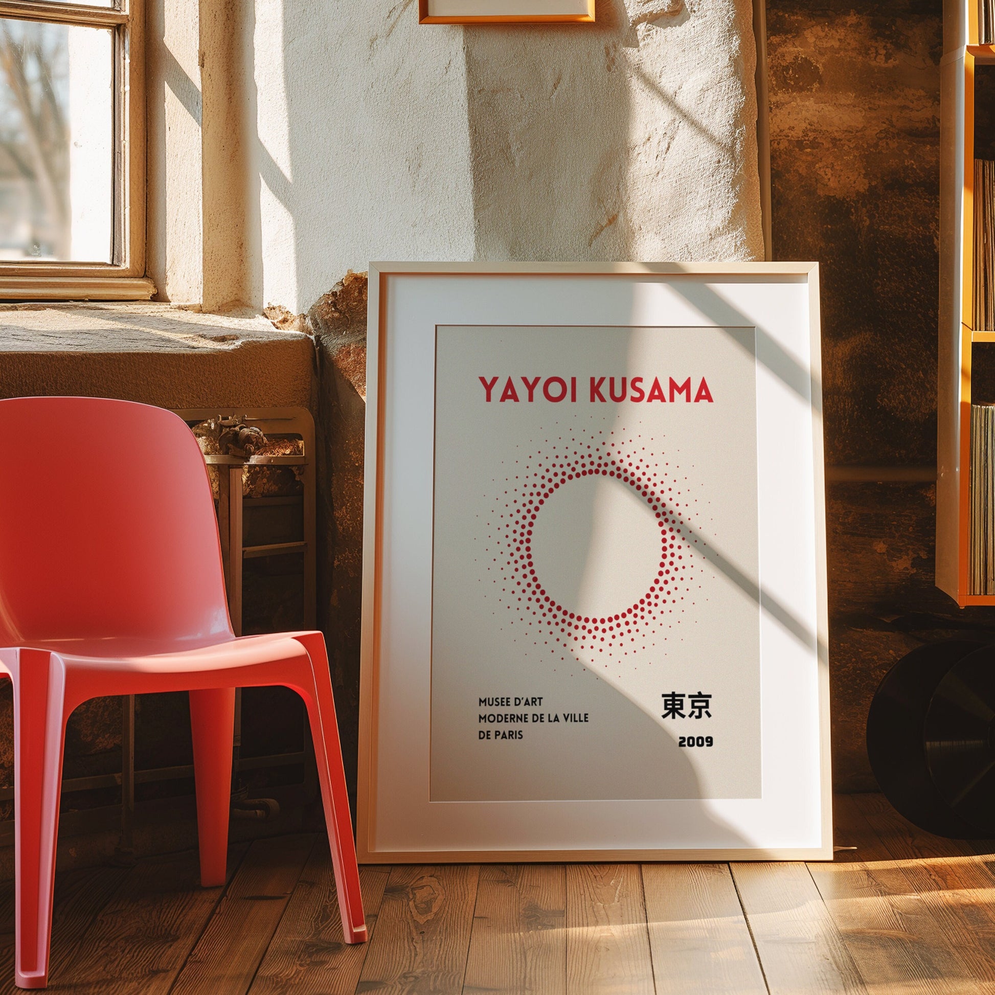 A Yayoi Kusama-inspired poster featuring a circular arrangement of red dots, evoking a minimalist and modern aesthetic. Displayed in a gold frame, with a cozy mid-century room decor.