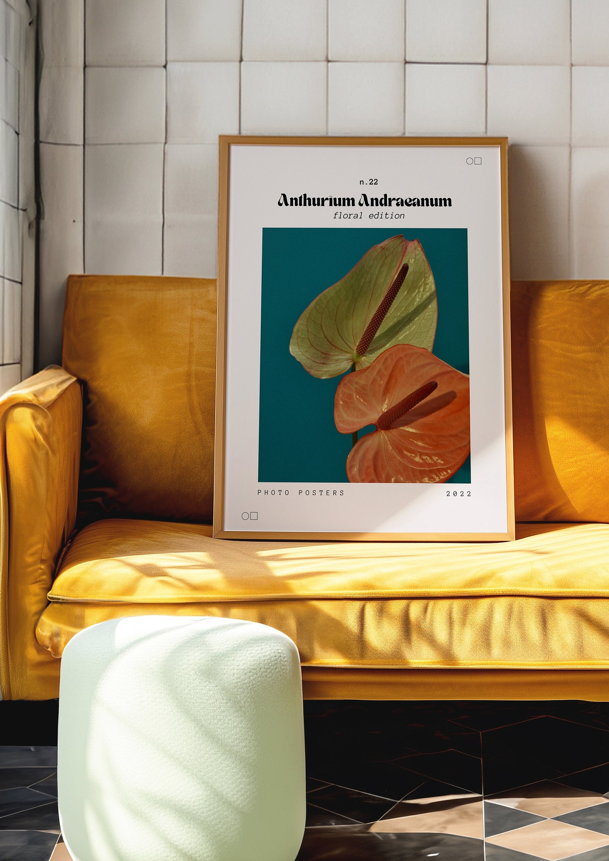 A framed Anthurium Andreanum poster showcasing a vibrant green and peach flower against a deep blue background, elegantly displayed in a warm, sunlit room with modern decor.