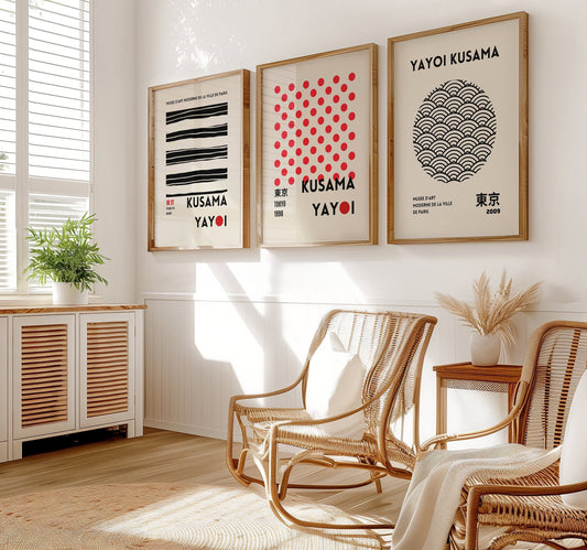 A set of three Yayoi Kusama posters featuring abstract line art, red dots, and minimalist black and white patterns, framed in wood and arranged on a wooden floor.