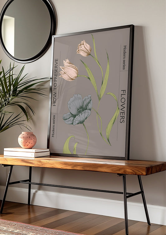 A vintage-style poster titled &quot;How to Preserve Flowers&quot; featuring detailed botanical illustrations of tulips and poppies, framed in gold. The poster is leaning against a rustic brick wall, bathed in soft natural light, creating a warm and nostalgic