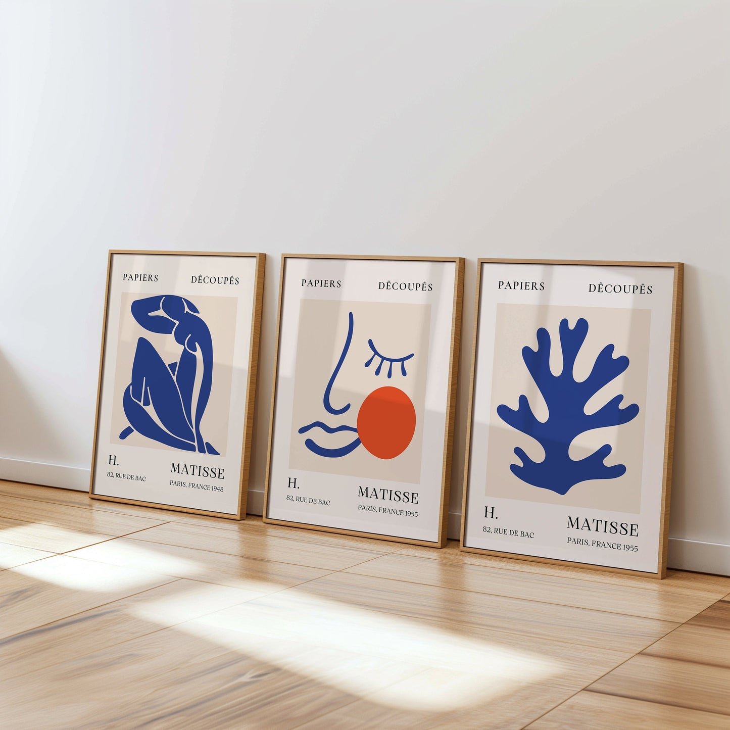 A trio of Henri Matisse posters featuring blue abstract cut-out designs and a minimalist face with an orange accent, part of the Papiers Découpés collection, perfect for modern decor.