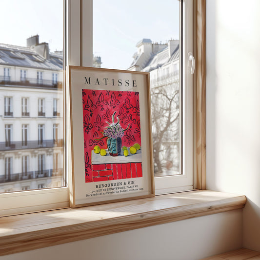 A vibrant still life poster inspired by Matisse, featuring a blue vase with flowers and lemons on a bold red patterned background.