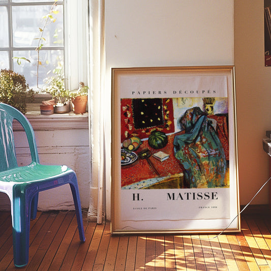 A vibrant still life poster inspired by Matisse, showcasing a colorful table setting with fruits and abstract patterns in bold red and green tones.