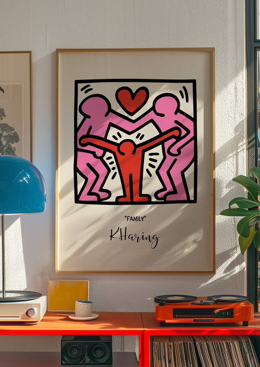 Keith Haring &quot;Family&quot; artwork showcasing two adults holding a child, with a heart symbol above, all in Haring&#39;s vibrant and bold line art style.