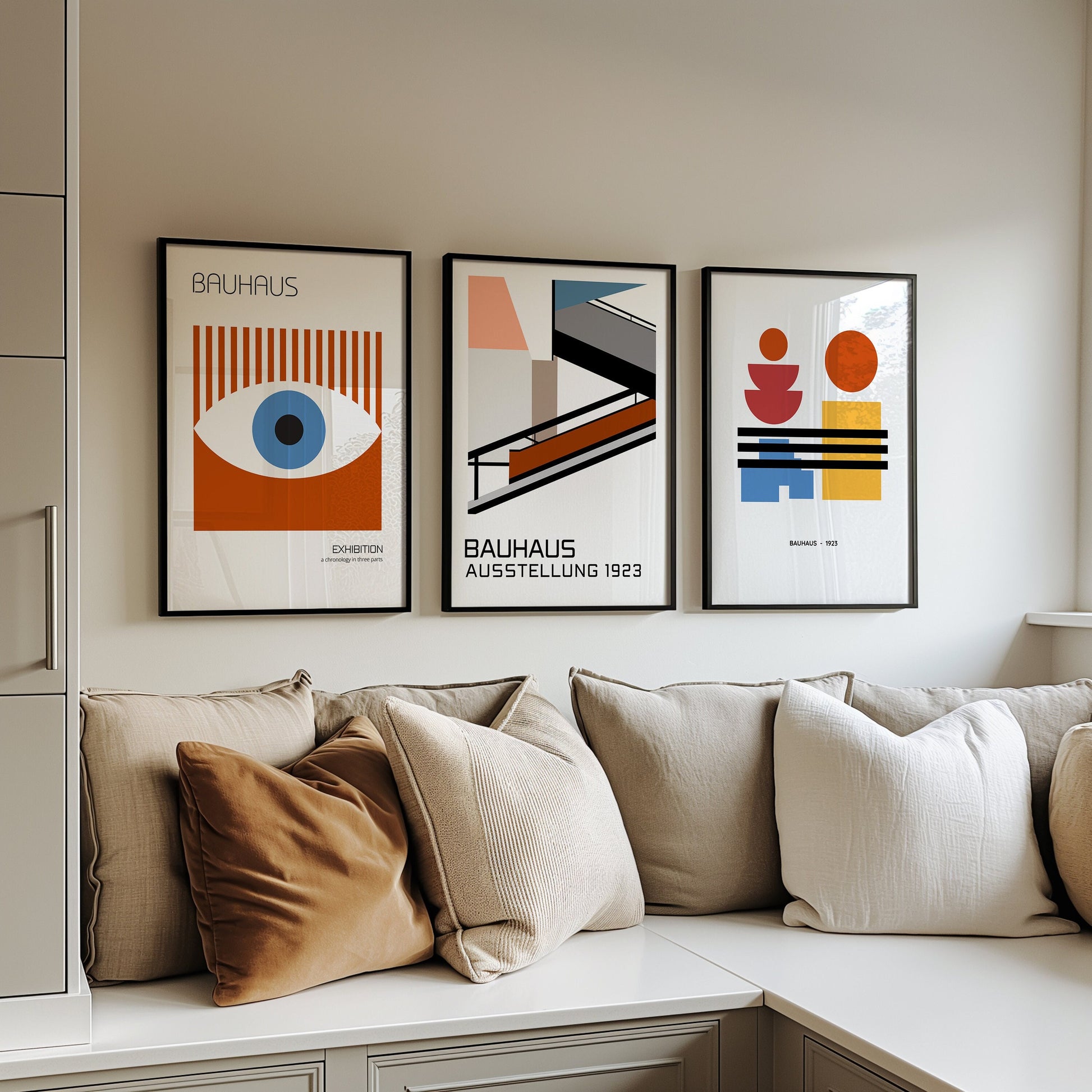 A set of three Bauhaus-inspired posters featuring minimalist geometric designs. Each print showcases different abstract forms in vibrant colors, framed and leaning against a wall, perfect for adding a modern touch to any room.