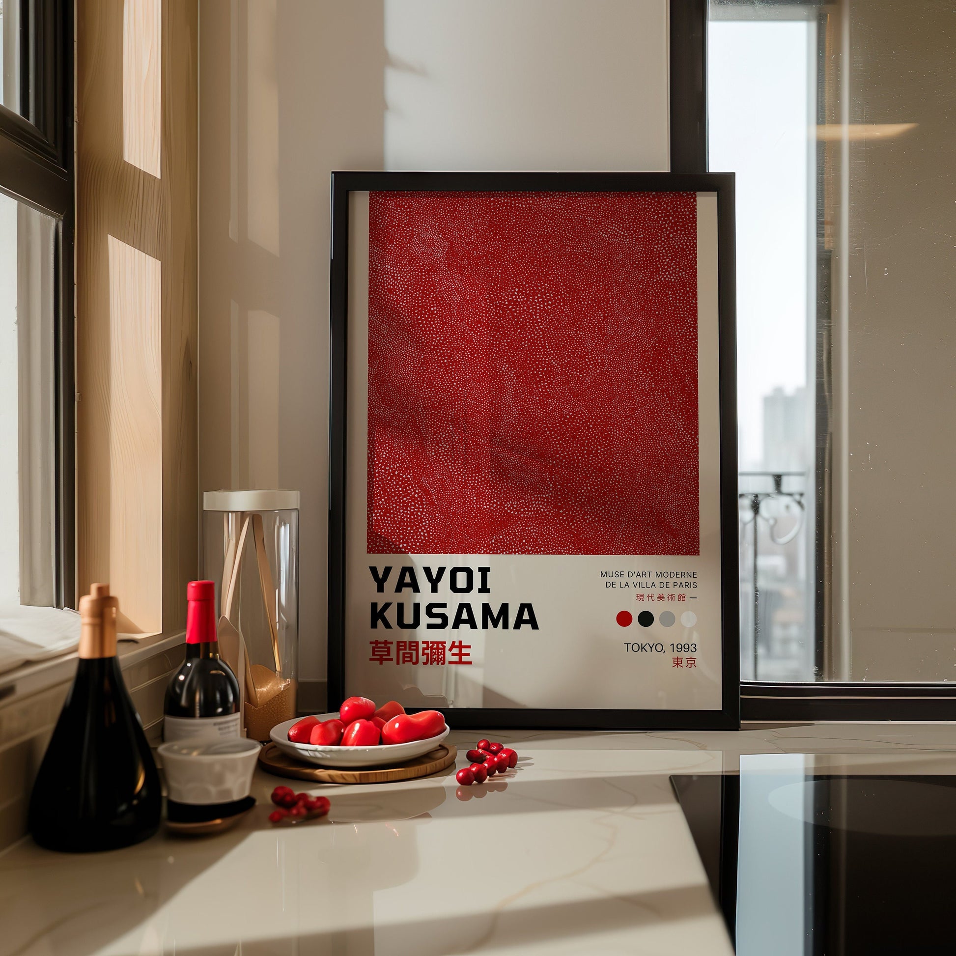 A striking Yayoi Kusama &quot;Infinity Net&quot; poster in rich red, displayed on a modern kitchen counter. The intricate, textured polka dots add a dynamic element to the minimalistic kitchen decor.