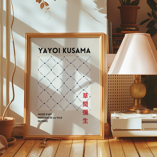 A Yayoi Kusama-inspired poster featuring a minimalist geometric pattern of small dots arranged in a diamond grid, displayed in a cozy room with warm sunlight and a gold frame.