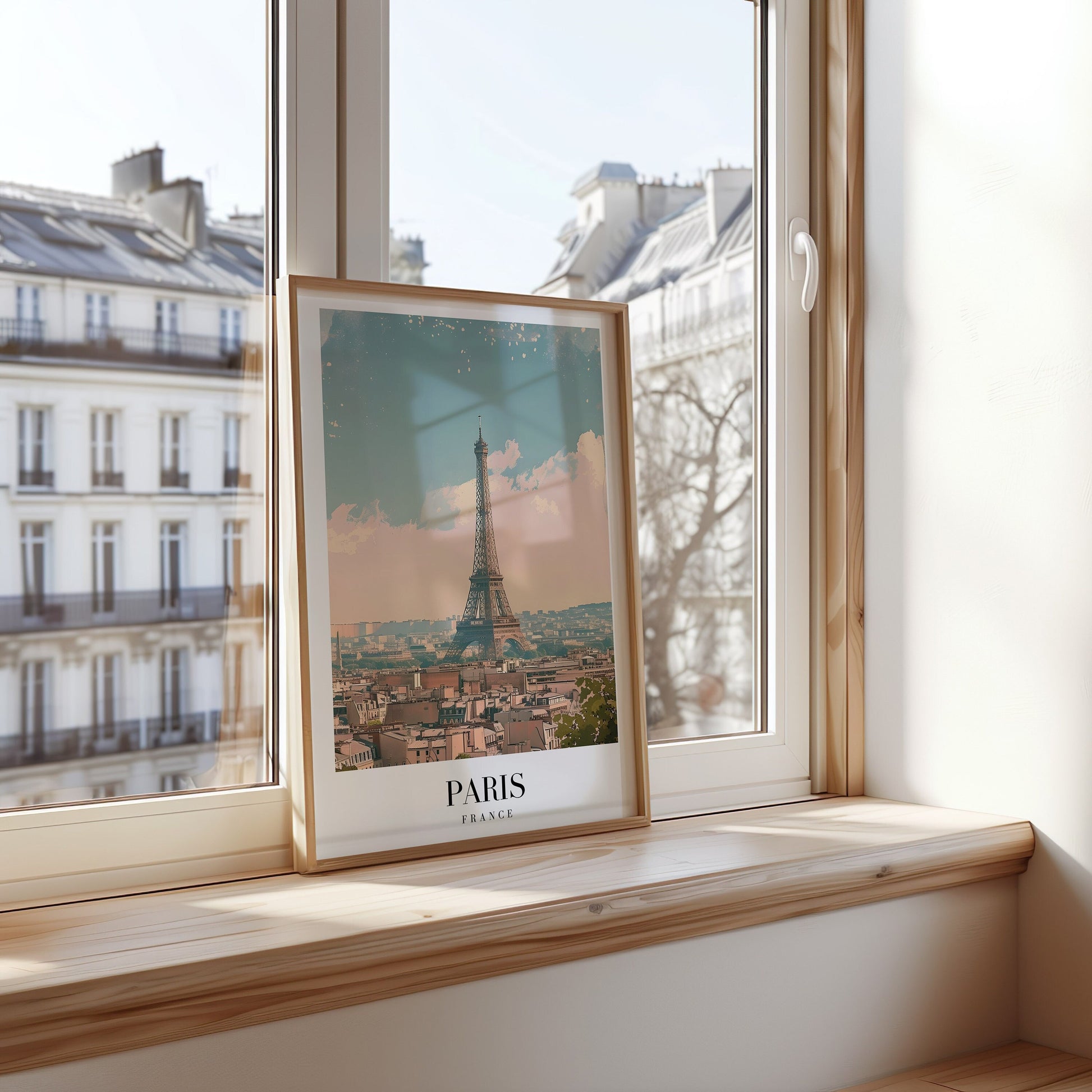 A framed poster of the Eiffel Tower rising above the Parisian skyline, bathed in soft, pastel tones of a calm day in Paris.