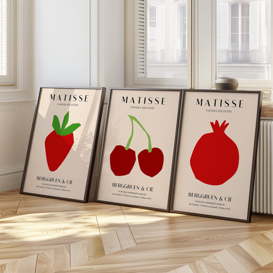 A minimalist set of Henri Matisse fruit-themed posters, featuring a strawberry, cherries, and a pomegranate, in bold red cut-out designs from the Berggruen & Cie 1953 collection.