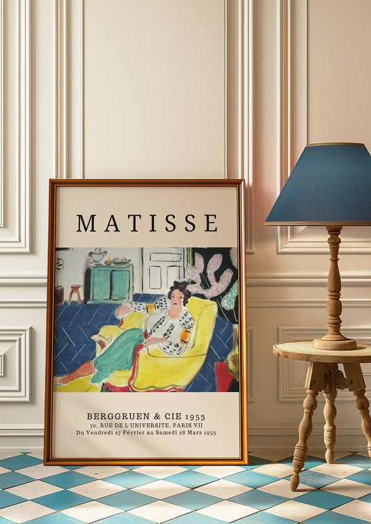 A Henri Matisse art print featuring a woman in a yellow chair, in a colorful and vibrant interior setting, displayed against an elegant home decor.