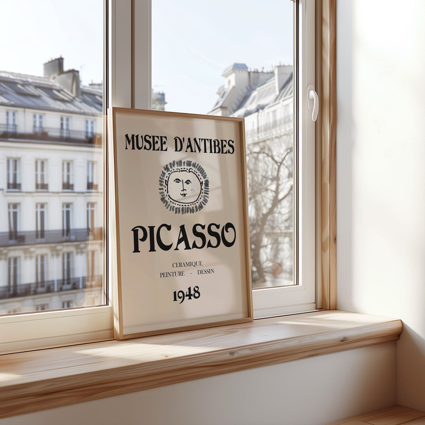 A vintage black-and-white Picasso poster featuring the iconic sun face from the 1948 Museum D&#39;Antibes exhibition, ideal for adding a touch of classic art to your kitchen or home.