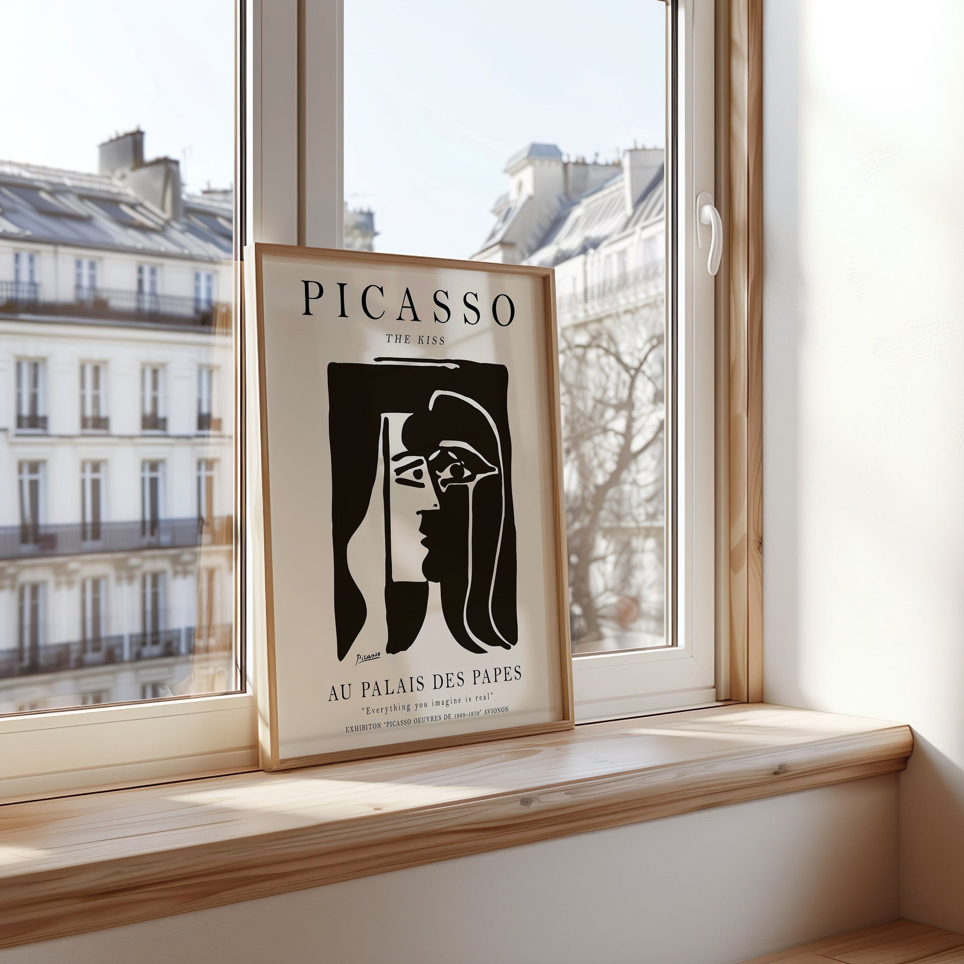 A black-and-white minimalist Picasso artwork titled &quot;The Kiss,&quot; portraying abstract faces, framed in a clean, modern style, perfect for contemporary decor.