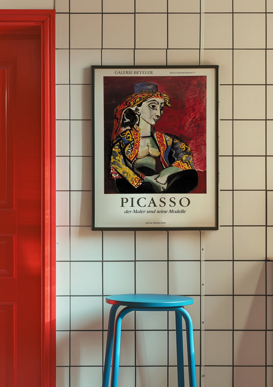 A vintage style German exhibition poster of Picasso, featuring an abstract portrait in vibrant colors, framed against a bold red background.